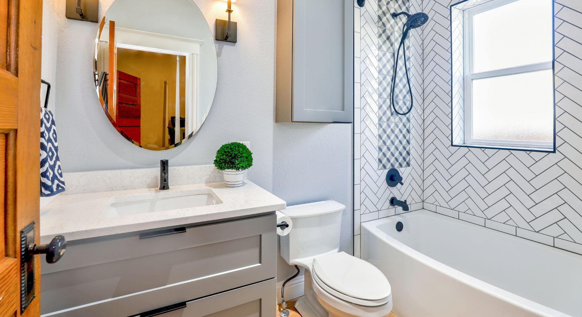 bathroom with herringbone tile and wood accents